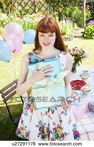 young woman holding present. View Large Photo Image Stock Photo - young woman holding present.. Fotosearch