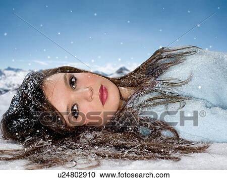 Young woman lays in snow portrait View Large Photo Image Stock Image - Young woman lays in snow portrait. Fotosearch