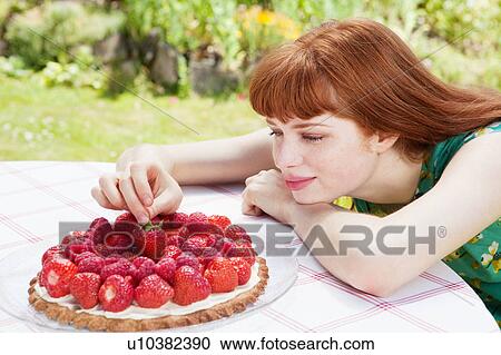 young woman picking strawberry of tart. View Large Photo Image Stock Image - young woman picking strawberry of tart.. Fotosearch