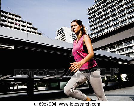 Picture - Young woman running. Fotosearch