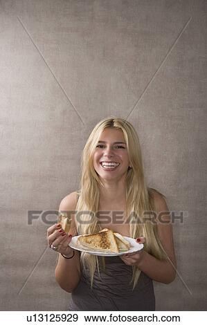 Young woman smiles with sandwich View Large Photo Image Stock Photo - Young woman smiles with sandwich. Fotosearch