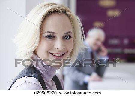 Young woman smiling at camera View Large Photo Image Stock Image - Young woman smiling at camera. Fotosearch