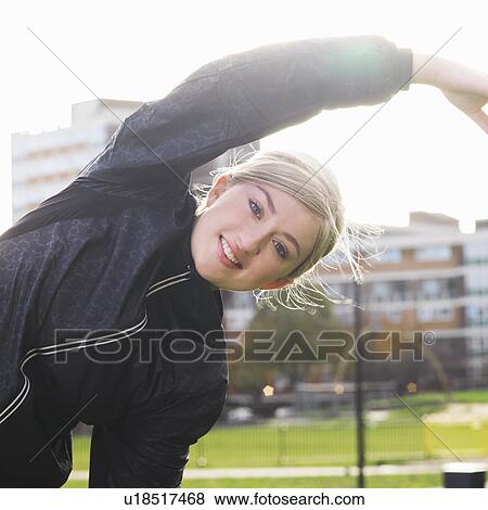 young woman stretching View Large Photo Image Stock Photo - young woman stretching. Fotosearch