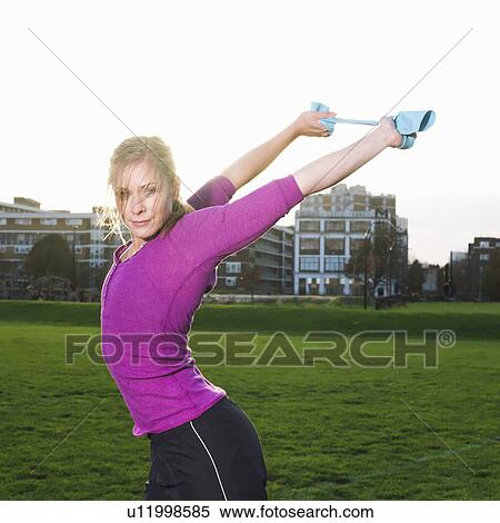 Young woman stretching View Large Photo Image Stock Photography - Young woman stretching. Fotosearch