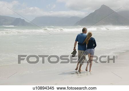 Young woman walking on beach with father View Large Photo Image Stock Photography - Young woman walking on beach with father. Fotosearch