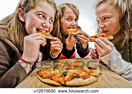 3 teenagers eating pizza View Large Photo Image Stock Image - 3 teenagers eating pizza. Fotosearch