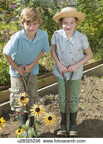 A boy and girl working in an allotment View Large Photo Image Stock Photograph - A boy and girl working in an allotment. Fotosearch