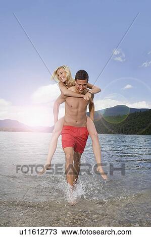 A boy carrying a girl View Large Photo Image Stock Image - A boy carrying a girl. Fotosearch