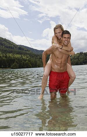 A boy carrying a girl View Large Photo Image Stock Photo - A boy carrying a girl. Fotosearch