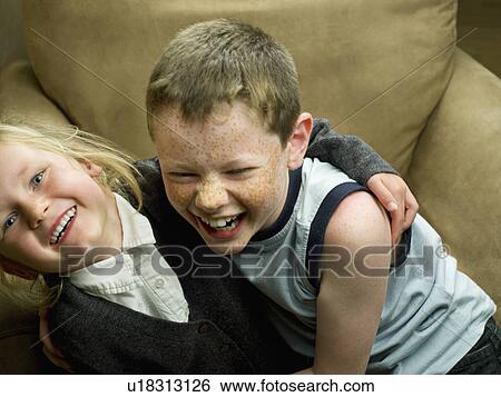 A brother and sister in an arm chair View Large Photo Image Stock Photograph - A brother and sister in an arm chair. Fotosearch