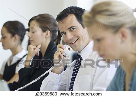 A business man talking on the phone View Large Photo Image Stock Image - A business man talking on the phone. Fotosearch