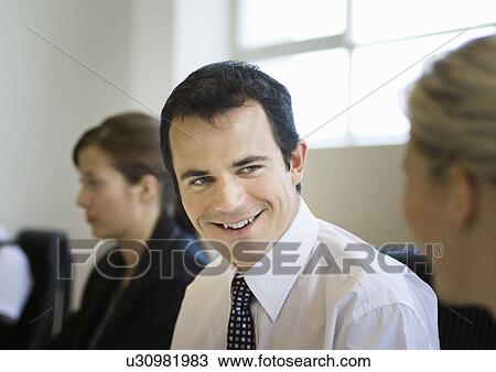 A business man talking to a colleague View Large Photo Image Stock Image - A business man talking to a colleague. Fotosearch