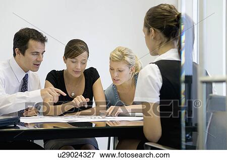 Stock Photo - A business meeting. Fotosearch