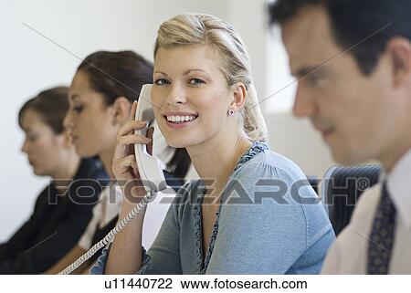 A business woman on the phone smiling View Large Photo Image Stock Image - A business woman on the phone smiling. Fotosearch