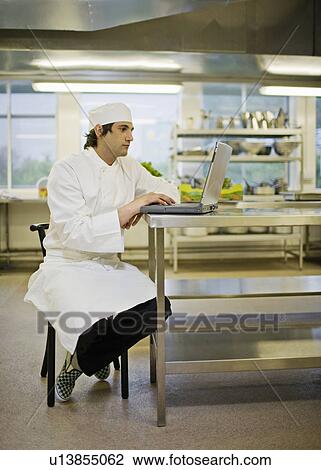 A chef working at his laptop View Large Photo Image Stock Image - A chef working at his laptop. Fotosearch