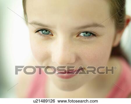 Stock Photograph - A close up portrait of a girls face. Fotosearch