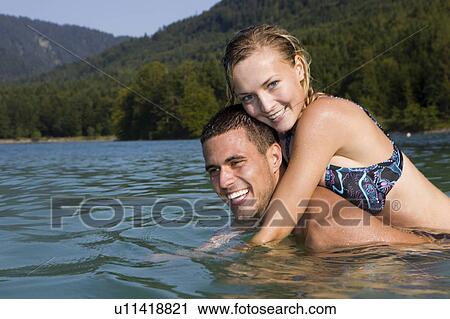 A couple having fun in the water View Large Photo Image Stock Image - A couple having fun in the water. Fotosearch