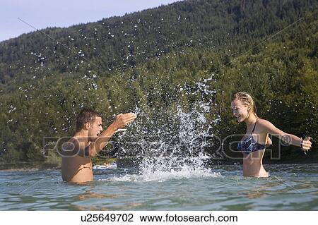 Stock Image - A couple having fun in the water. Fotosearch