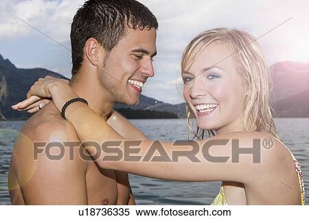 Stock Photography - A couple hugging and laughing. Fotosearch