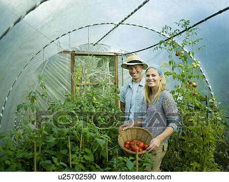 A couple in a green house View Large Photo Image Stock Image - A couple in a green house. Fotosearch