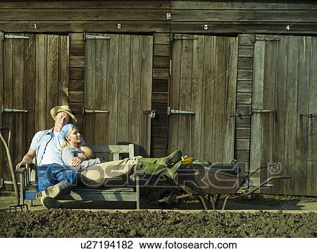 Stock Image - A couple relaxing in an allotment. Fotosearch