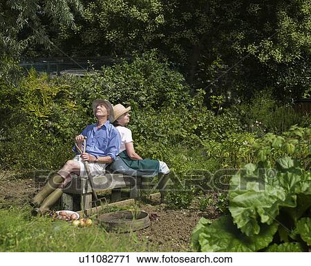 A couple take a break from gardening View Large Photo Image Stock Image - A couple take a break from gardening. Fotosearch