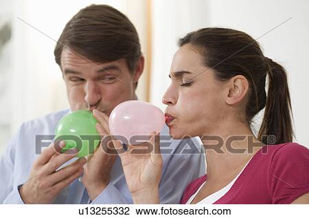 a couple trying to blow balloons View Large Photo Image Stock Image - a couple trying to blow balloons. Fotosearch