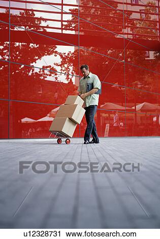 A courier delivers parcels View Large Photo Image Stock Image - A courier delivers parcels. Fotosearch