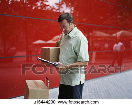Stock Image - A courier delivers parcels. Fotosearch
