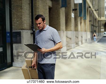 A courier delivers parcels View Large Photo Image Stock Image - A courier delivers parcels. Fotosearch
