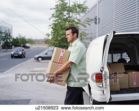 Stock Image - A courier delivers parcels. Fotosearch