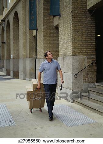 Stock Image - A courier delivers parcels. Fotosearch
