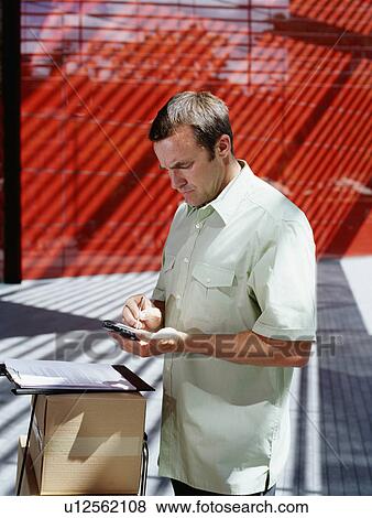 Stock Photo - A courier delivers parcels. Fotosearch