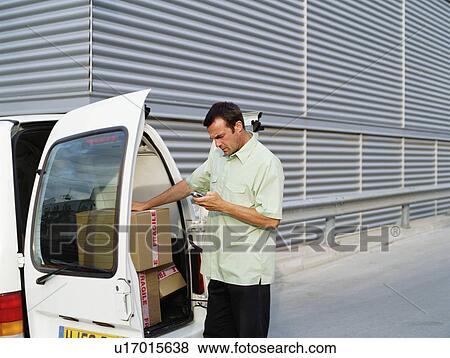 Stock Photo - A courier delivers parcels.. Fotosearch