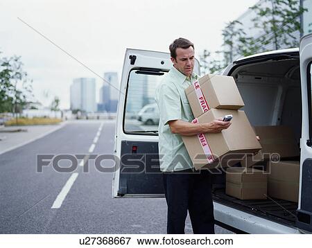 A courier delivers Parcels View Large Photo Image Stock Photo - A courier delivers Parcels. Fotosearch