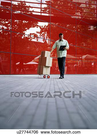 A courier delivers parcels View Large Photo Image Stock Photograph - A courier delivers parcels. Fotosearch