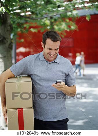 Stock Photography - A courier delivers parcels. Fotosearch