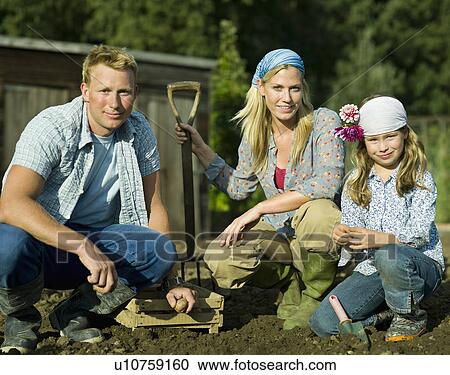 Stock Image - A family in a vegetable garden. Fotosearch