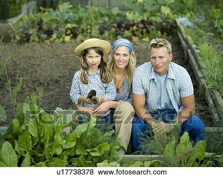 A family portrait in an allotment View Large Photo Image Stock Photo - A family portrait in an allotment. Fotosearch