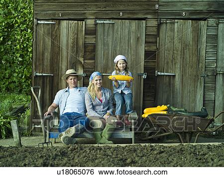 Stock Photograph - A family portrait in an allotment. Fotosearch