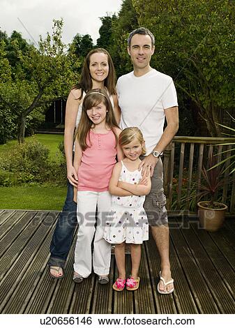 Stock Photograph - A family portrait in the garden. Fotosearch