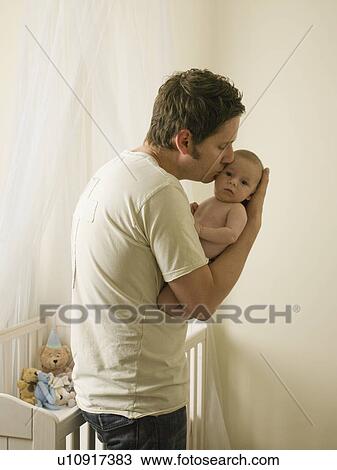 A father holding his new born baby View Large Photo Image Stock Image - A father holding his new born baby. Fotosearch