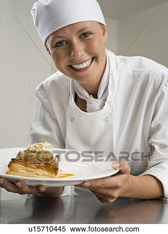A female chef holding a pastry desert View Large Photo Image Stock Photography - A female chef holding a pastry desert. Fotosearch