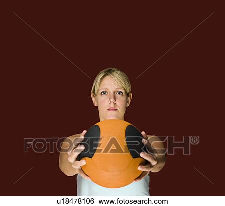 Stock Photograph - A female holding a basket ball. Fotosearch