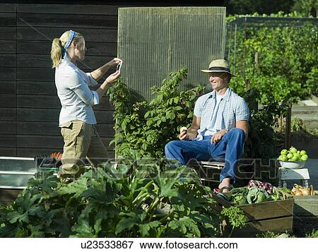 Stock Photo - A female taking a photo of a male. Fotosearch
