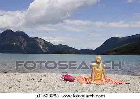 A girl relaxing on a beach towel View Large Photo Image Stock Image - A girl relaxing on a beach towel. Fotosearch