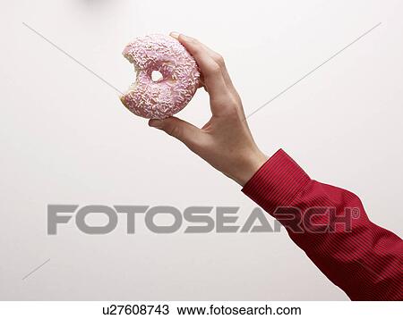 A Hand holding a doughnut View Large Photo Image Stock Image - A Hand holding a doughnut. Fotosearch