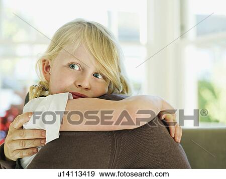 A little girl hugging a loved one View Large Photo Image Stock Photo - A little girl hugging a loved one. Fotosearch