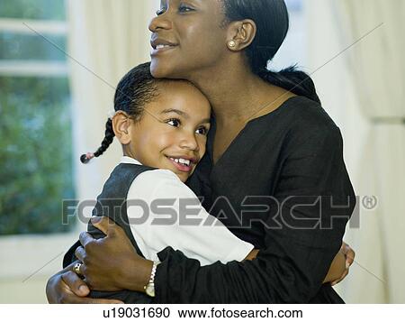 A little girl hugging her mother View Large Photo Image Stock Image - A little girl hugging her mother. Fotosearch