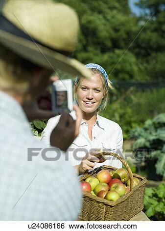 Stock Photograph - A male taking a photo of a female. Fotosearch